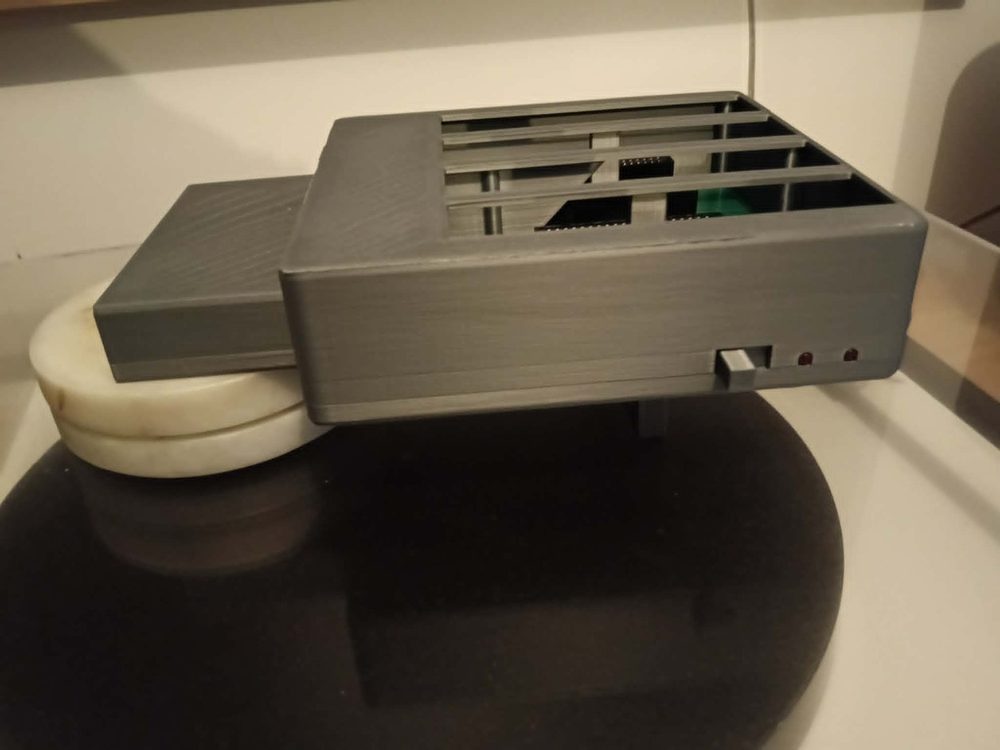 8BITCRUSH Multi-Pak in a grey 3D-printed case, showing four cartridge slots